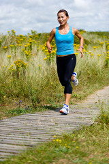 A young woman running in the countryside