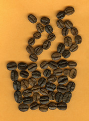 Cup made of coffee beans on pink background.