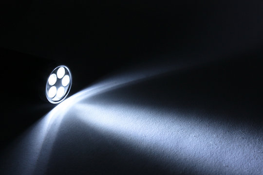 Beam from flashlight closeup on paper