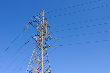 High-voltage line on blue sky background