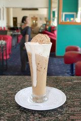 beverage at bar, waitress at background
