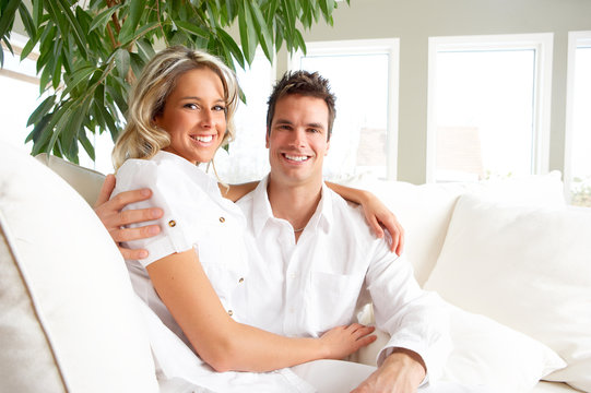 Young love couple smiling in the comfortable apartment.