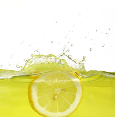 Image of lemon slice falling into juice