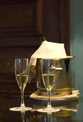 champagne glasses and bottle in hotel suite for celebration