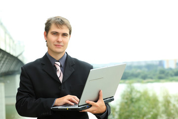 Business background: handsome businessman in a work process.