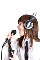 Obraz premium Woman in headphones Singing in Microphone