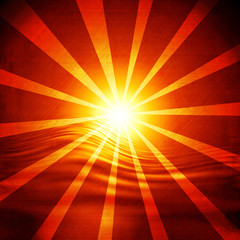 Glowing sunset with rays on a red background