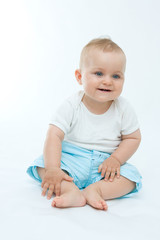 cute laughing baby boy sitting on white background