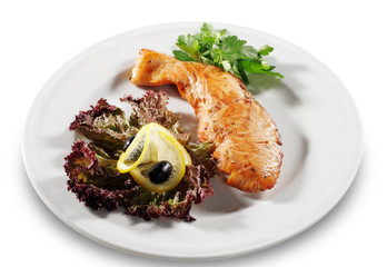 Steak from Filleted Fish (Salmon) with Lemon Slice and Salad