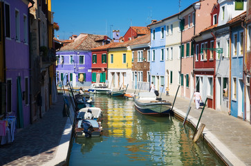 Fototapeta na wymiar Small canal in Venice Italy. Multicolored traditional buildings.