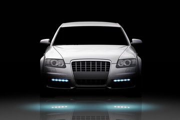 Naklejka premium Front view of a luxury sport sedan isolated on black