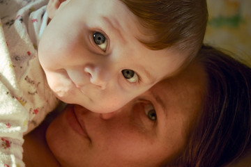 The child has gently nestled on mother. Only persons