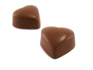 Two delicious and symbolic heart shaped chocolates.