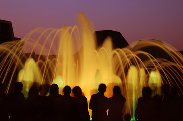 Fountain light show with people silhouettes