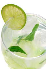 Mojito cocktail with a lime on white background..
