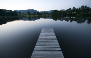 Obraz premium Bootssteg auf den spiegelglatten See bei Windstille