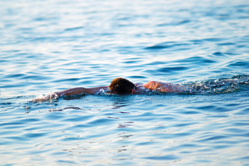 Fototapeta premium swimming man in ocean water