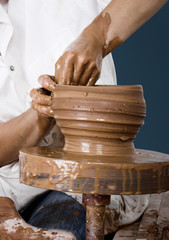 Close-up picture of a potter works a potter's wheel