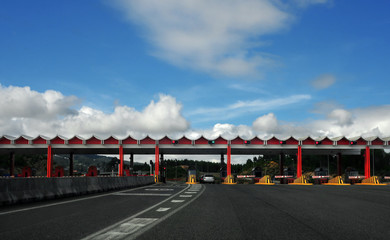 landscape view of a highway toll with cars passin trhough