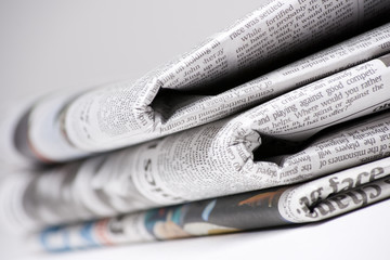 Newspapers on light background with shallow depth of focus