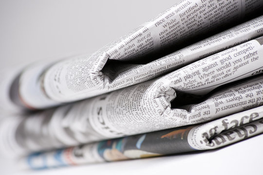Newspapers on light background with shallow depth of focus