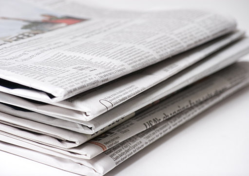 Newspapers on light background with shallow depth of focus
