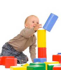 little boy play with bricks. isolated on a white background