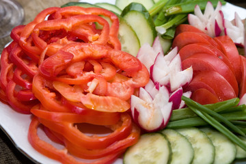Salad from tomatoes, cucumbers, a garden radish, an onions