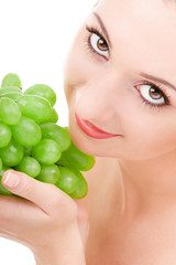 pretty woman with green grape isolated on the white background