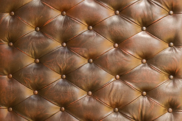 Natural buttoned brown leather texture. Close up.