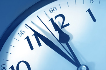 Clockface showing just before midnight.  Blue toned image