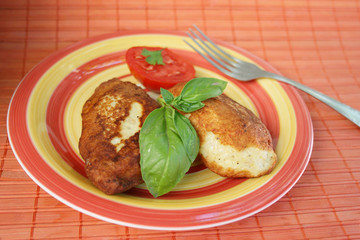 Juicy pork chops with a garnish from greens.