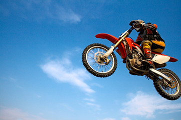 Fototapeta na wymiar man on motorcycle on background blue sky