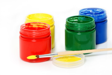 Water based paints and brush on a white background.
