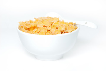 Cereal flakes in a blue bowl on white background