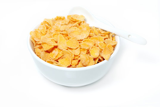 Cereal flakes in a blue bowl on white background