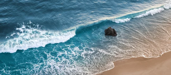 Peel and stick wall murals Aerial view beach A wave breaking on a beach in central California.