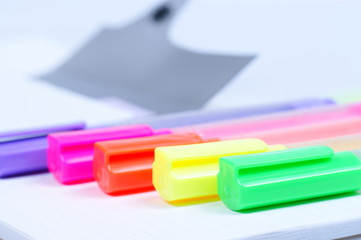 Colorful markers over a white background.