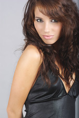 Naklejka premium Sexy girl wearing black dress on grey background
