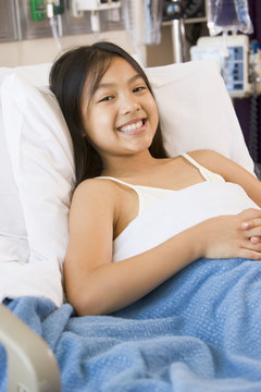 Young Girl Smiling,Lying In Hospital Bed