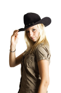 young rodeo cowgirl  holding cowboy hat