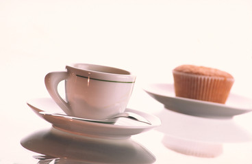 cup of coffee with  spoon in  plate and plate with  fruitcake
