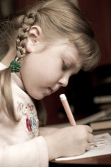 An image of little girl with pencil