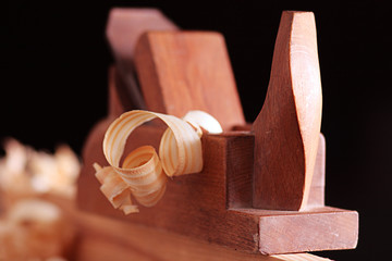 Old wooden plane and shaving