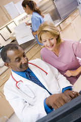 Fototapeta premium A Doctor And Nurse Discussing Something At The Reception Area Of