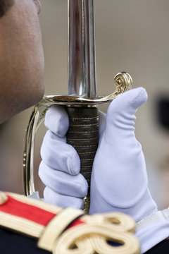 Military honour guard presenting arms holding sword