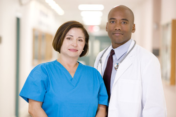 A Doctor And Nurse Standing In A Hospital Corridor