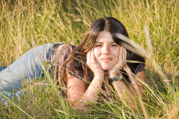 young woman enjoying a field with grass.