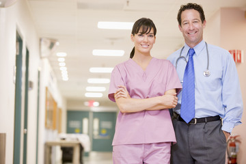 Doctor And Nurse Standing In A Hospital Corridor