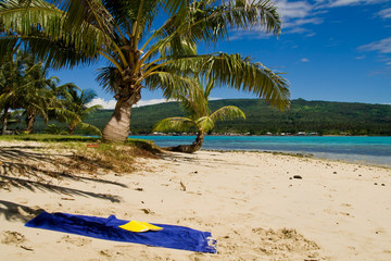 blue towel on the white samoan sand